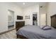 Cozy bedroom showcasing a wooden dresser, closet, and ensuite bathroom entrance at 16368 W Watkins St, Goodyear, AZ 85338