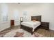 Bedroom featuring a wood-framed bed, a bedside table, and a decorative rug at 16368 W Watkins St, Goodyear, AZ 85338