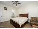 Spacious bedroom featuring a large bed, hardwood floors, and views into an en suite bathroom at 16368 W Watkins St, Goodyear, AZ 85338