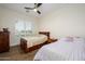 Cozy bedroom with wood floors, two beds, bright window, and ceiling fan at 16368 W Watkins St, Goodyear, AZ 85338