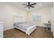 Bright bedroom featuring a bed with side table and wooden floors at 16368 W Watkins St, Goodyear, AZ 85338