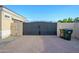 An ornate wrought-iron security gate at the end of a paver driveway, providing privacy and curb appeal at 16368 W Watkins St, Goodyear, AZ 85338