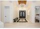 Elegant foyer with a stunning chandelier, marble flooring, and double front doors at 16368 W Watkins St, Goodyear, AZ 85338
