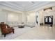 Elegant foyer featuring double doors, a stylish chandelier, and a bench upon decorative flooring at 16368 W Watkins St, Goodyear, AZ 85338