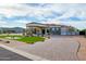 A luxurious property with a circular driveway, grand entrance, and meticulously maintained landscaping at 16368 W Watkins St, Goodyear, AZ 85338