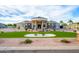 Stunning home featuring a circular driveway, portico entry, and lush green lawn with custom landscaping at 16368 W Watkins St, Goodyear, AZ 85338