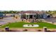 Elegant home featuring a circular driveway, manicured lawn, water feature, and stone accents on the facade at 16368 W Watkins St, Goodyear, AZ 85338