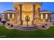 Grand entrance featuring stately columns, lush green space, and a tranquil water feature at 16368 W Watkins St, Goodyear, AZ 85338