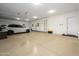 Spacious garage with epoxy flooring, storage shelves, and parking for vehicles at 16368 W Watkins St, Goodyear, AZ 85338