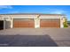Spacious three-car garage with stylish doors and ample parking space on a paved driveway at 16368 W Watkins St, Goodyear, AZ 85338