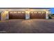 Well-lit three car garage featuring a stone paver driveway at 16368 W Watkins St, Goodyear, AZ 85338