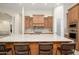 Spacious kitchen with granite countertops, custom cabinets, and an island with barstool seating at 16368 W Watkins St, Goodyear, AZ 85338