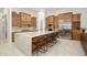 Bright kitchen featuring custom cabinets, granite counters, stainless appliances, and a large island at 16368 W Watkins St, Goodyear, AZ 85338
