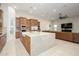 Gourmet kitchen featuring an oversized island, custom wood cabinets, and stainless steel appliances at 16368 W Watkins St, Goodyear, AZ 85338