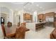 Open-concept kitchen with granite countertops, a large island, and custom cabinets at 16368 W Watkins St, Goodyear, AZ 85338