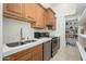 Features a stainless steel sink, appliances, and wood cabinetry complemented by a convenient walk-in pantry at 16368 W Watkins St, Goodyear, AZ 85338