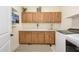 Bright laundry room boasts wood cabinets, a sleek white countertop, and modern washer and dryer at 16368 W Watkins St, Goodyear, AZ 85338