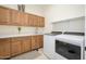 Spacious laundry room with modern appliances, sink, counter, and ample cabinet space at 16368 W Watkins St, Goodyear, AZ 85338