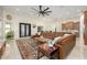 Bright living room featuring a leather sectional, patterned rug, and an open concept design at 16368 W Watkins St, Goodyear, AZ 85338