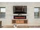 Inviting living room featuring a stone accent wall, fireplace, and neutral flooring at 16368 W Watkins St, Goodyear, AZ 85338