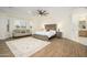 Spacious primary bedroom with trey ceiling, seating area, and wood-look floors at 16368 W Watkins St, Goodyear, AZ 85338