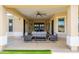 Covered patio features comfortable seating, a ceiling fan, and elegant columns, creating an inviting outdoor living space at 16368 W Watkins St, Goodyear, AZ 85338