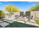 Entertainer's backyard with built-in grill, cozy fire pit, and artificial turf, perfect for outdoor gatherings at 18129 N 65Th Pl, Phoenix, AZ 85054