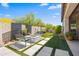 Backyard featuring an inviting fire pit, comfortable seating, and easy-care artificial turf at 18129 N 65Th Pl, Phoenix, AZ 85054
