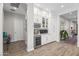 Stylish bar area with custom cabinetry, wine storage, and a beverage refrigerator, perfect for entertaining guests at 18129 N 65Th Pl, Phoenix, AZ 85054
