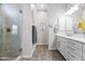 Bathroom with glass enclosed shower, and neutral vanity and countertop showcasing modern fixtures and ample space at 18129 N 65Th Pl, Phoenix, AZ 85054