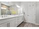 Bright bathroom showcasing double vanity with white countertops, modern fixtures, and a large mirror for added elegance at 18129 N 65Th Pl, Phoenix, AZ 85054