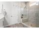 Bathroom featuring a glass-enclosed shower with a built-in bench and neutral-toned tile, showcasing modern design at 18129 N 65Th Pl, Phoenix, AZ 85054