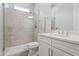 Beautiful bathroom featuring walk-in shower with tiled walls and bright, modern vanity with quartz countertops at 18129 N 65Th Pl, Phoenix, AZ 85054