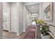 Hallway with wood-look tile flooring, neutral walls, area rugs and decorative accents at 18129 N 65Th Pl, Phoenix, AZ 85054