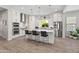 Modern kitchen featuring an island with seating, stainless steel appliances, and wood-look flooring for a warm and inviting feel at 18129 N 65Th Pl, Phoenix, AZ 85054