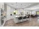 Well-lit kitchen with a center island, stainless steel appliances, and sleek white cabinets, perfect for modern living at 18129 N 65Th Pl, Phoenix, AZ 85054