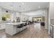 Spacious open-concept kitchen featuring a large island with seating, stainless steel appliances, and bright, airy design at 18129 N 65Th Pl, Phoenix, AZ 85054