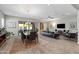 Open-concept living space combining dining and living areas, featuring modern furnishings and plenty of natural light at 18129 N 65Th Pl, Phoenix, AZ 85054