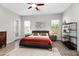 Well-lit main bedroom featuring wood-look floors, a black leather bed, and a calming neutral color scheme at 18129 N 65Th Pl, Phoenix, AZ 85054