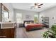 Serene main bedroom with wood-look floors, a black leather bed, neutral walls, and plenty of natural light at 18129 N 65Th Pl, Phoenix, AZ 85054