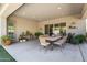 Charming covered patio with ample space for dining and entertaining with views of the lush landscaping at 18129 N 65Th Pl, Phoenix, AZ 85054