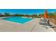 Resort-style community pool with lounge chairs, umbrellas, and well-maintained landscaping at 18129 N 65Th Pl, Phoenix, AZ 85054