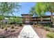 Entrance to the community pool, surrounded by desert landscaping at 18129 N 65Th Pl, Phoenix, AZ 85054