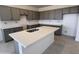 Spacious kitchen featuring gray cabinets, an island with a sink, and white subway tile backsplash at 20601 N 226Th Dr, Surprise, AZ 85387