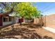 A large backyard with mature trees and a clear view of the sky at 2122 W Piccadilly Rd, Phoenix, AZ 85015