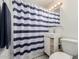 Fresh bathroom featuring a striped shower curtain, modern sink and toilet at 2122 W Piccadilly Rd, Phoenix, AZ 85015