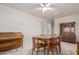 Cozy dining room featuring a ceiling fan, and classic wooden furniture including a piano and hutch at 2122 W Piccadilly Rd, Phoenix, AZ 85015
