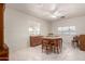Bright dining room featuring a ceiling fan, tile flooring, and ample natural light at 2122 W Piccadilly Rd, Phoenix, AZ 85015
