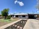 Charming single-story home with a well-manicured front yard and a covered carport at 2122 W Piccadilly Rd, Phoenix, AZ 85015