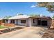 Spacious single-story home with a long driveway, covered carport, and a well-maintained front yard at 2122 W Piccadilly Rd, Phoenix, AZ 85015
